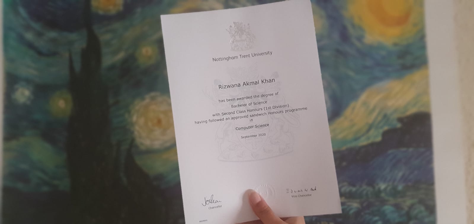 me, holding up my degree